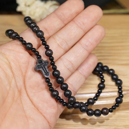 AMUSOUL Crucifix of 6*8 mm Round Black Sandalwood Nylon Cord Rosary