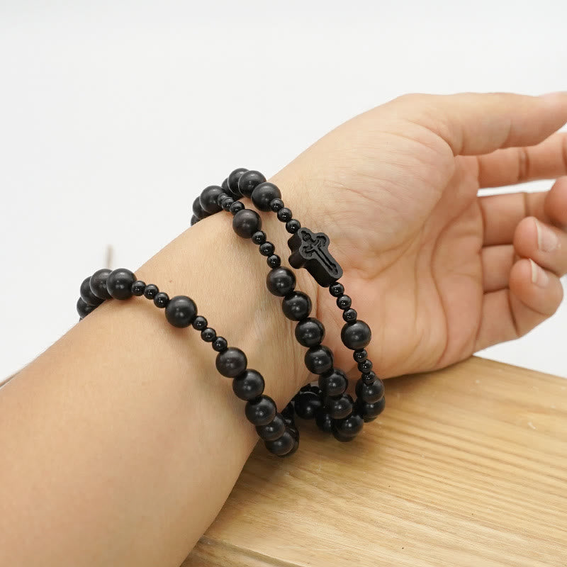 AMUSOUL Crucifix of 6*8 mm Round Black Sandalwood Nylon Cord Rosary