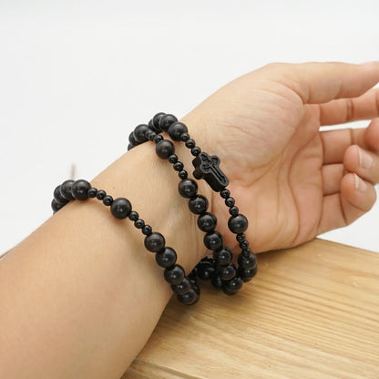 AMUSOUL Crucifix of 6*8 mm Round Black Sandalwood Nylon Cord Rosary