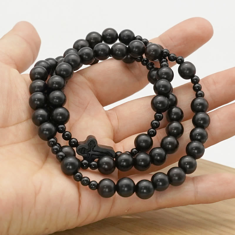 AMUSOUL Crucifix of 6*8 mm Round Black Sandalwood Nylon Cord Rosary