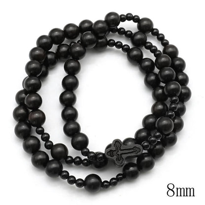 AMUSOUL Crucifix of 6*8 mm Round Black Sandalwood Nylon Cord Rosary