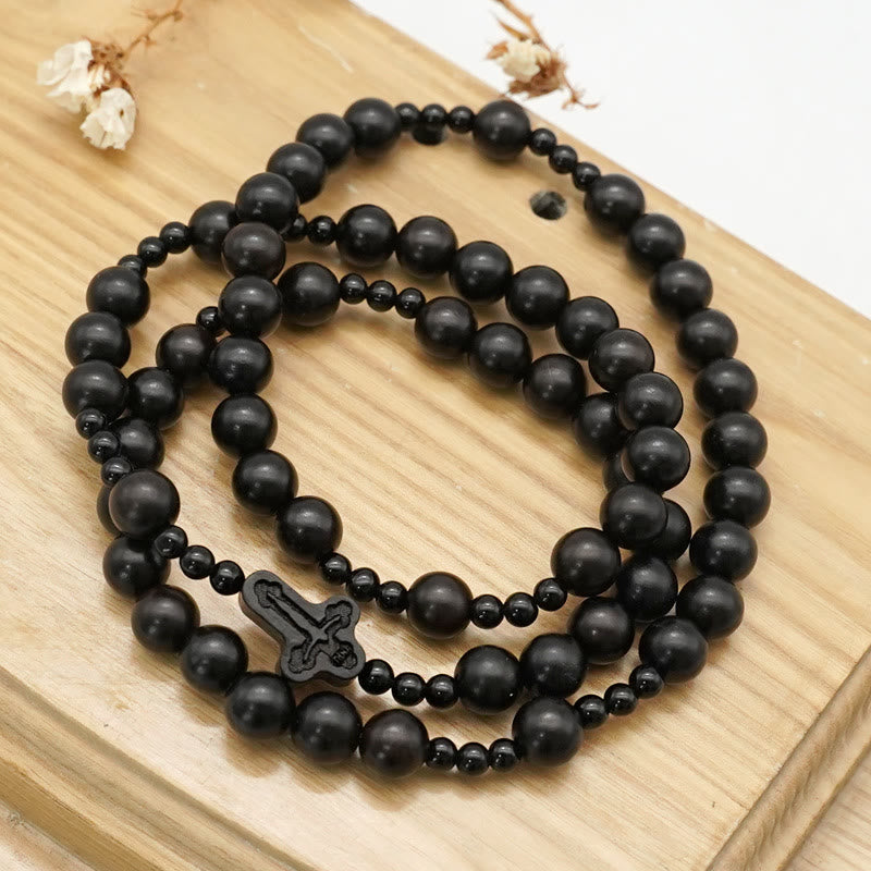 AMUSOUL Crucifix of 6*8 mm Round Black Sandalwood Nylon Cord Rosary