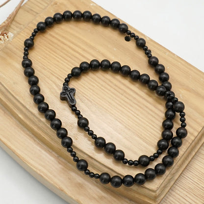 AMUSOUL Crucifix of 6*8 mm Round Black Sandalwood Nylon Cord Rosary
