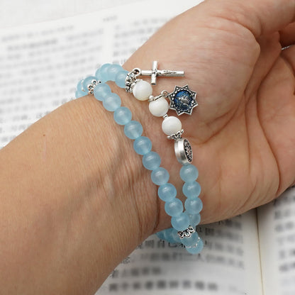 AMUSOUL  6mm Light Blue Bead Miraculous Medal & Crucifix Minimalist Bracelet: A Symbol of Faith